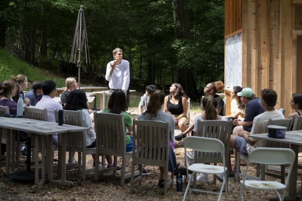 Director of the Shepherd Program Howard Pickett talks to a Volunteer Venture group in an outdoor classroom.